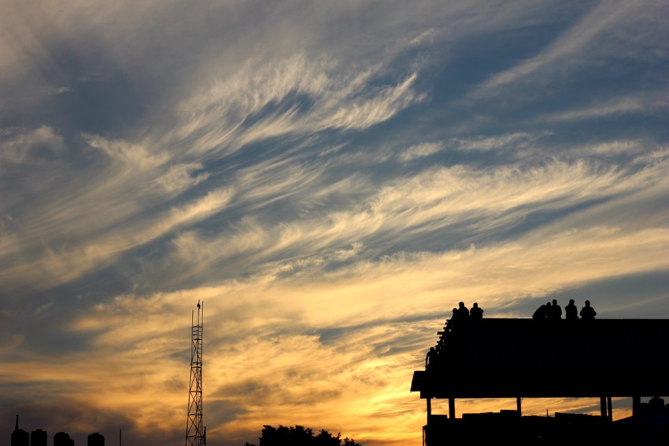 Silhouette Of Building With People Standing During Golden Hour photo