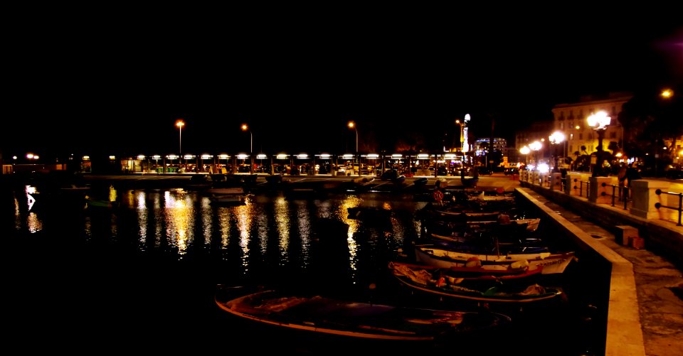 White Boats Near Gray Post Light During Night Time photo