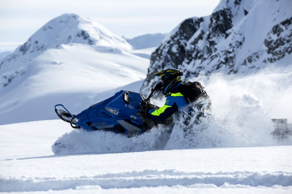 Person Riding On Snowmobile