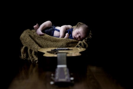 Baby On Beige Textile Near Brown Dreadnought Acoustic Guitar