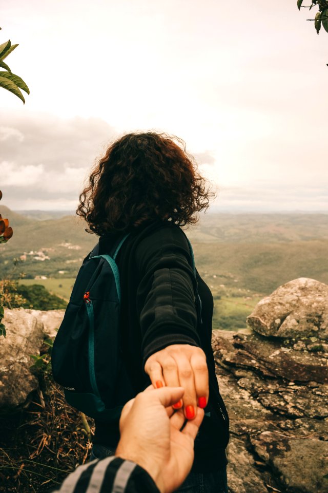 Woman Wearing Black Long-sleeved Shirt Holding Someones Hand photo