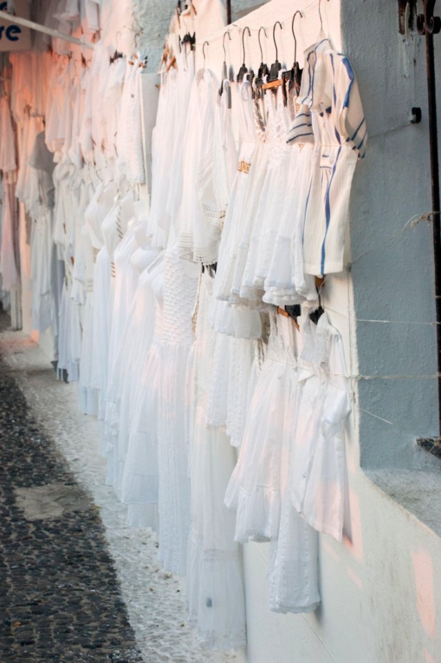 Assorted Dresses Hanged On White Painted Wall