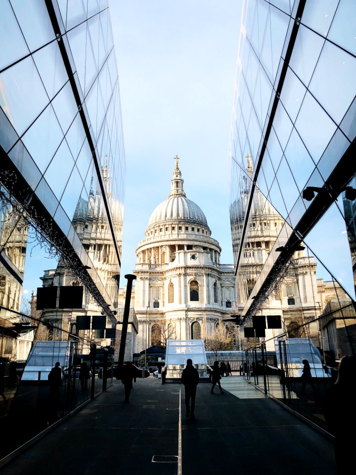 White Dome Cathedral In Between Curtain Wall Building At Daytime