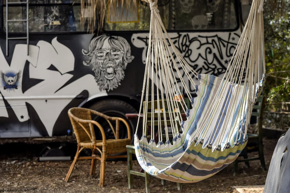 Multicolored Hammock Near Brown Rattan Armchair