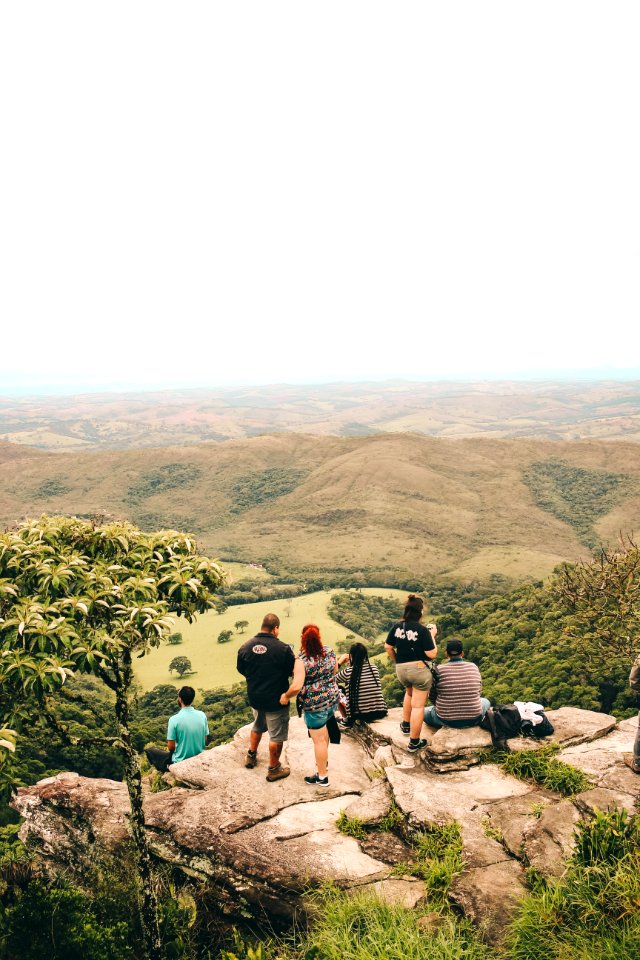 People Sitting And Standing On The Edge If Cliff