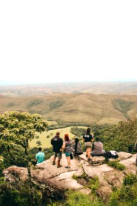 People Sitting And Standing On The Edge If Cliff photo