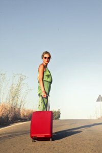 Photo Of A Woman Holding Her Luggae photo