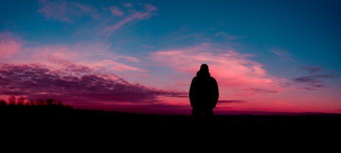 Silhouette Of Human With Sunset Background