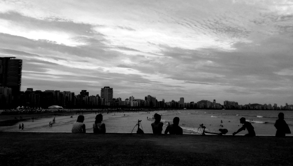 Gray Scale Photo Of Group Of People Near On Beach photo