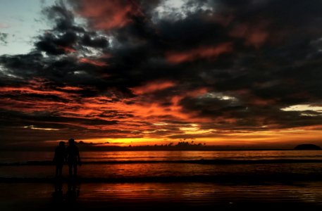Two Person Standing On Beach Silhouette Photo