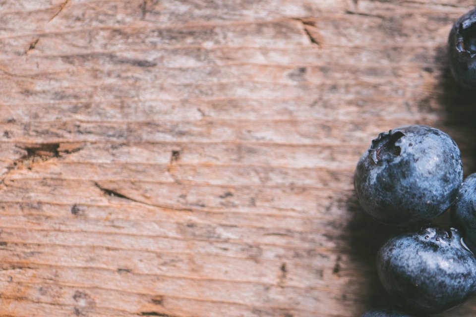 Close-Up Photography Of Blueberries On Wooden Surface photo