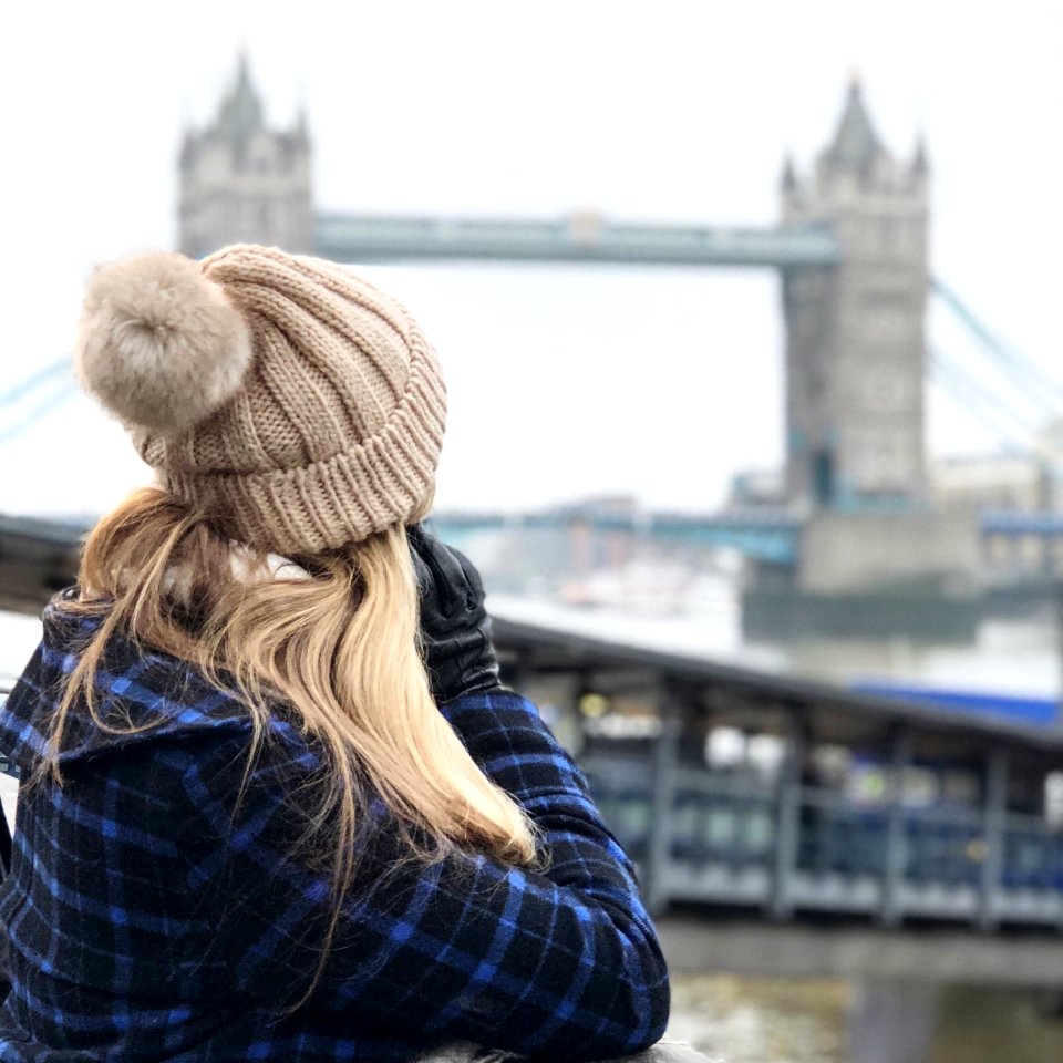 Woman Wearing Brown Beanie Holding Smartphone photo