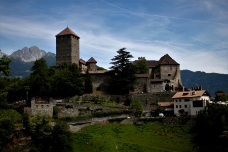 Beige Bricked Castle Surrounded With Green Grasses Under Blue Sky
