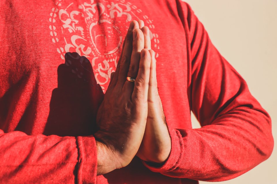Person Wearing Gold Ring And Red Long Sleeve Top