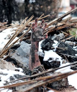 Person Buried Under Grey Stone And Black Soils photo