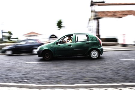 Photography Of A Person Driving Green Car photo