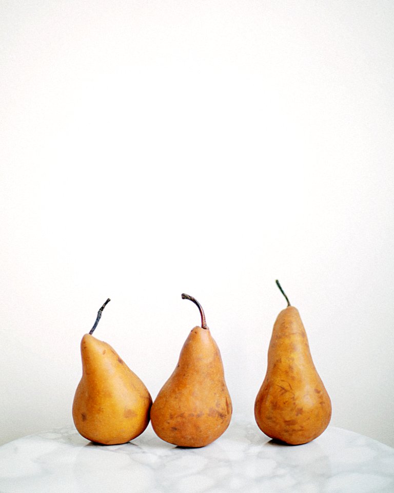 Three Brown Fruits On White Textile
