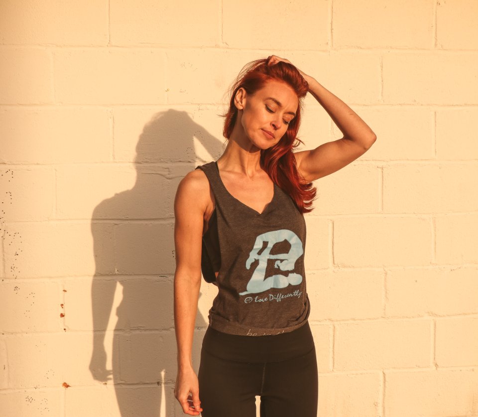 Woman In Gray And Black Tank Top Standing Near Wall