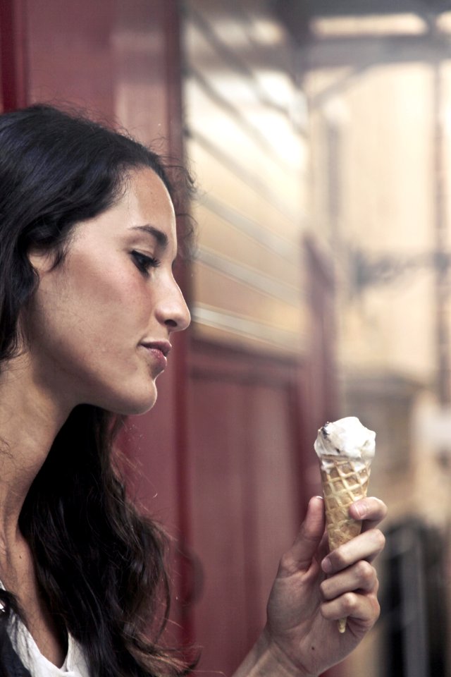 Photography Of A Woman Holding Ice Cream photo