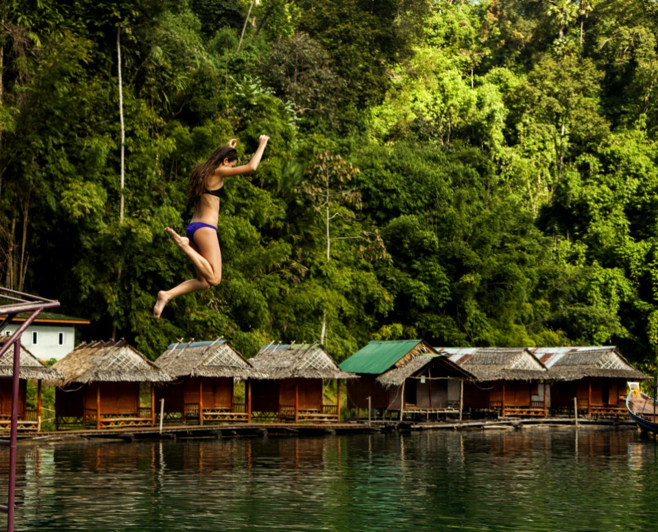 Photography Of A Woman Jumping Into The Water