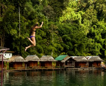 Photography Of A Woman Jumping Into The Water