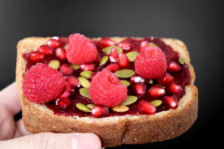 Person Holding Brown Bread With Strawberries photo