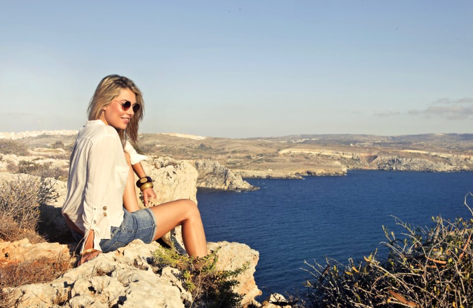 Photo Of A Woman Sitting On The Cliff