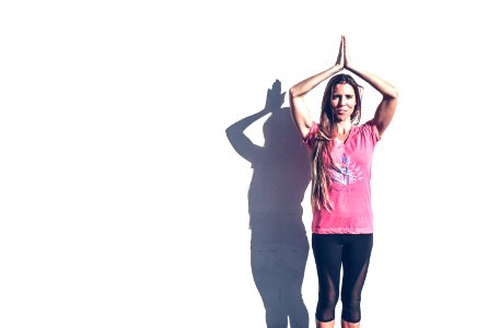 Woman In Pink Crew-neck T-shirt And Black Leggings Standing Near White Wall photo