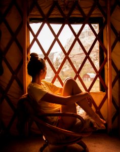 Photography Of Woman Sitting On Brown Wicker Chair During Sunset photo