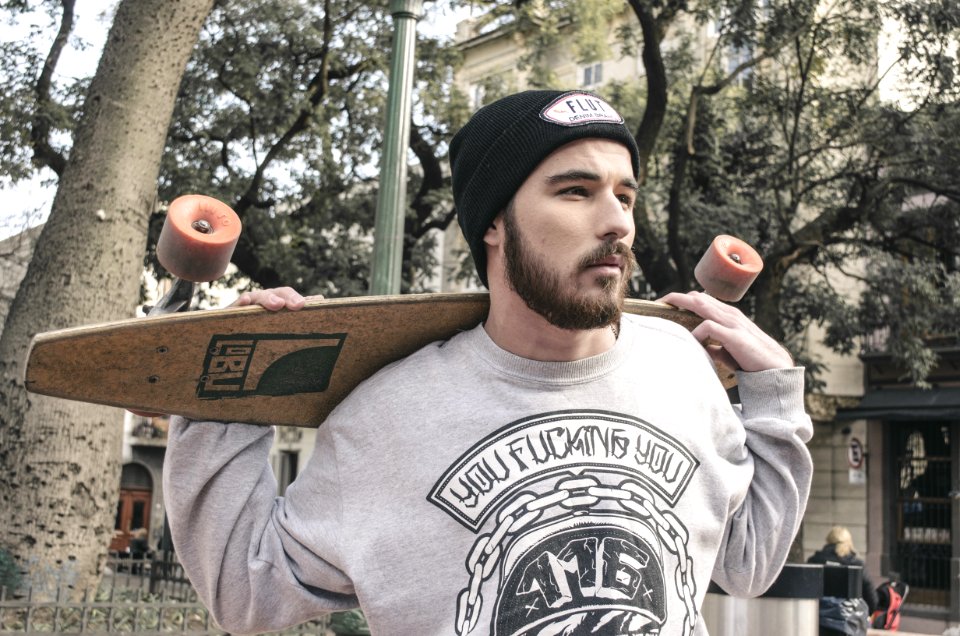 Photography Of A Man Holding Longboard photo