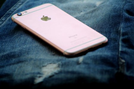 Close-Up Photography Of Rose Gold Iphone 6s On Top Of Blue Denim Jeans photo