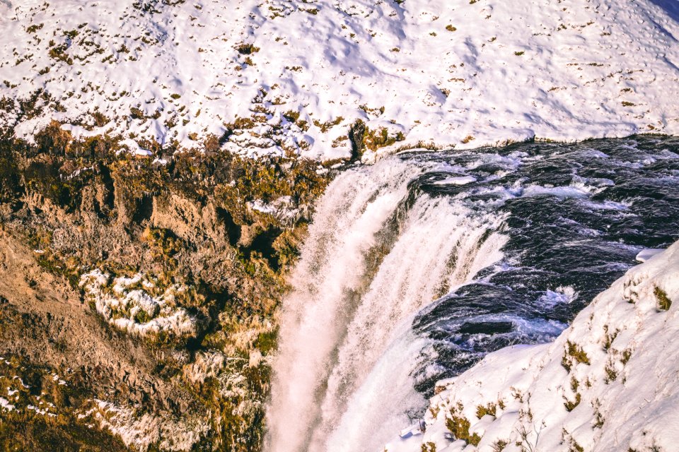 Water Falls Beside Mountains With Snow