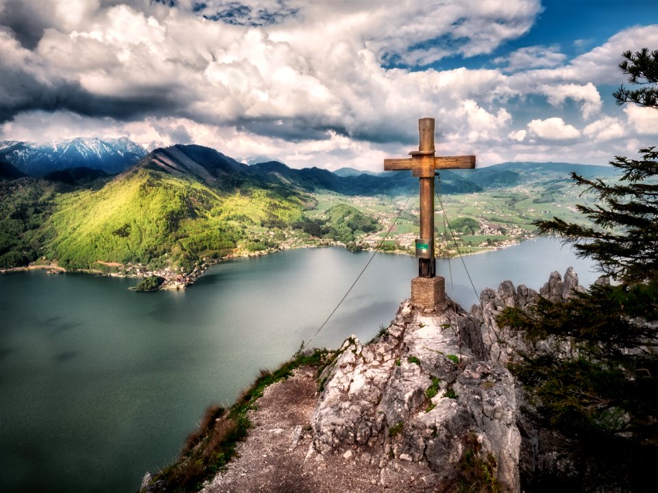 Brown Cross Near Body Of Water Under White Sky