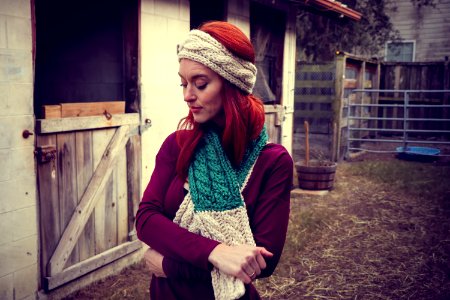 Woman In Purple Sweatshirt Wearing Knitted Beanie And Scarf photo