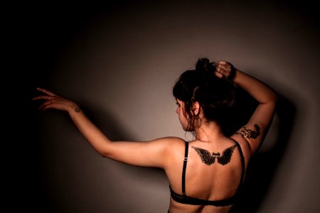 Woman In Eagle Tattoo In Back Wearing Black Bra photo