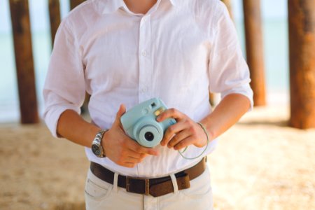Man Holds Blue Fujufilm Instax Mini Camera