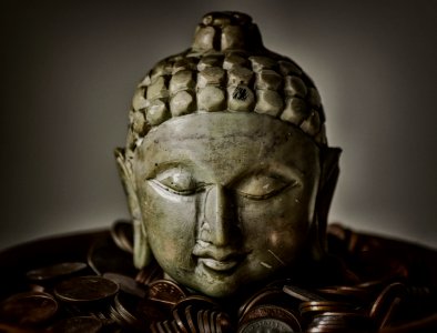 Gautama Buddha Bust Surrounded By Coins