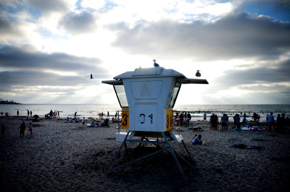 People Near Sea Under White And Blue Sky