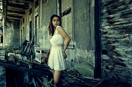 Photo Of Woman Wearing White Dress Standing Near Abandoned Building photo