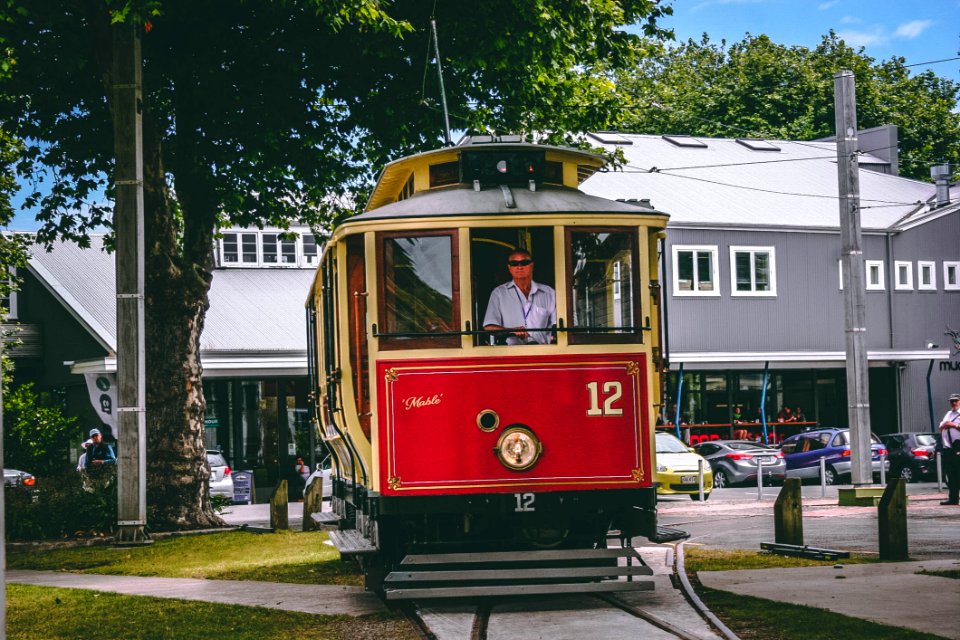 Man Riding On Red And Beige Train photo