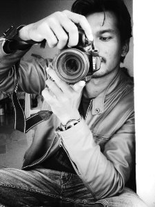 Monochrome Photography Of Man Holding Black Nikon Camera photo