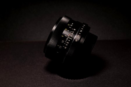 Black Camera Lens On Black Textile photo