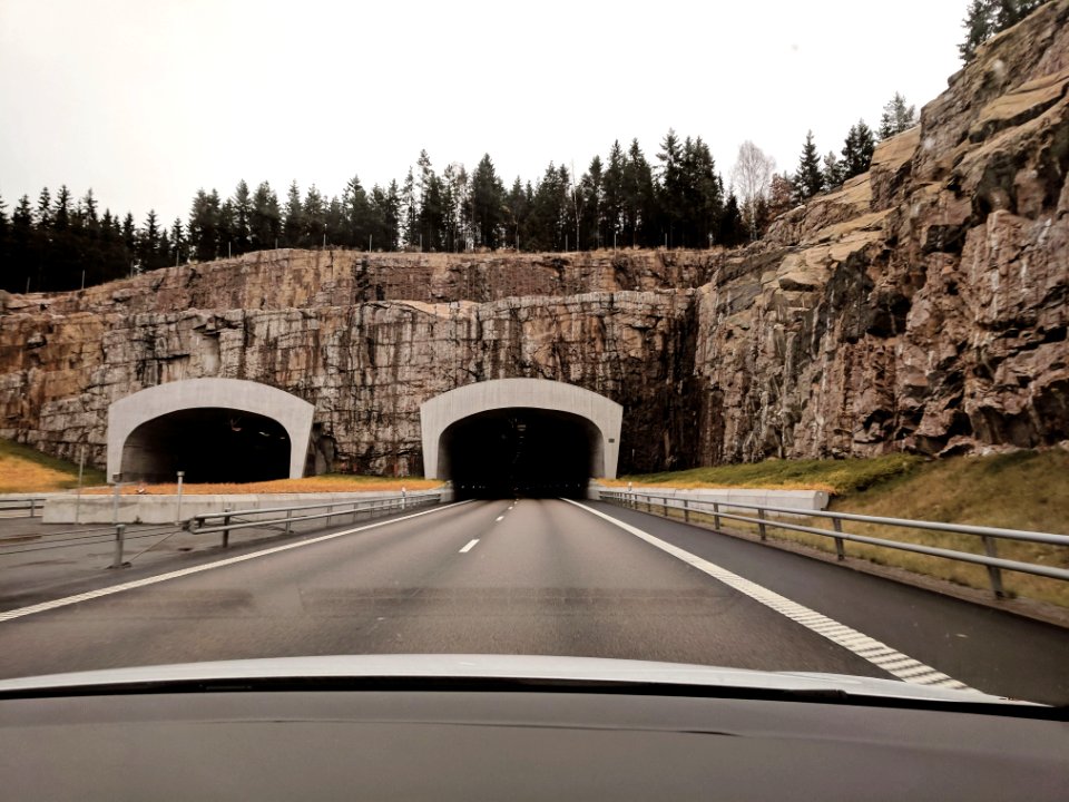 Photo Of Two Highway Tunnels In Cliff Under Cloudy Sky