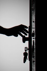 Silhouette Photo Of Person Holding Door Knob photo