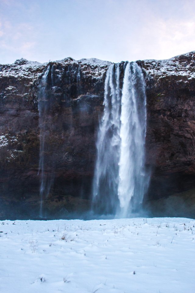 Snow Falling From Cliff Photo