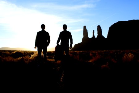 Silhouette Of Two Person Standing On The Desert photo
