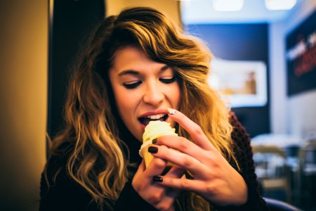 Long Blonde Haired Woman Eating Ice Cream photo