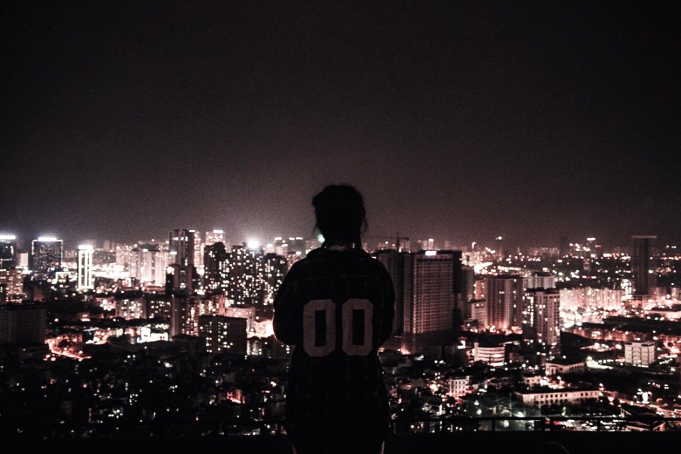 Photo Of A Person Watching Over City Lights During Night Time photo