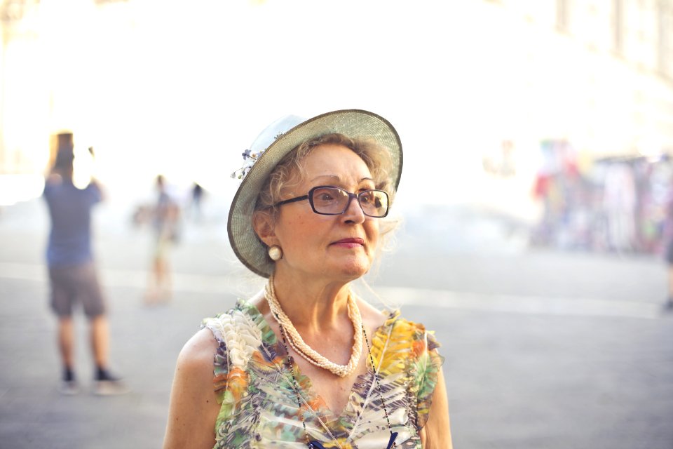 Depth Of Field Photography Of Woman In Pastel Color Sleeveless Shirt And White Sunhat
