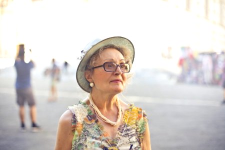 Depth Of Field Photography Of Woman In Pastel Color Sleeveless Shirt And White Sunhat